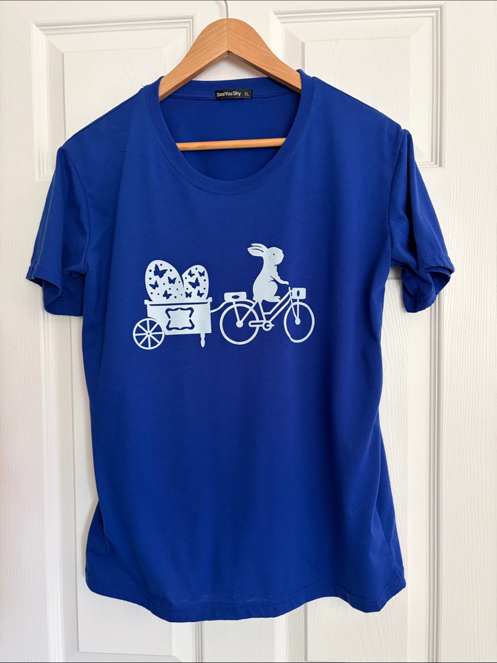 See You Shy Women’s Cobalt Blue Tee with White Bunny Bicycle Graphic, size XL